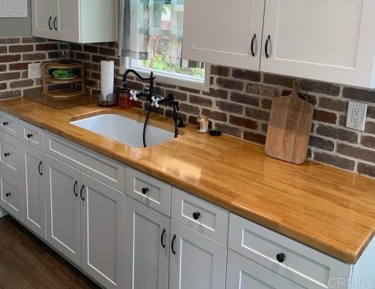 4989 Porter Hill Road La Mesa, CA 91942 - Photo 10 of 22 a kitchen with counter top space and wooden floor