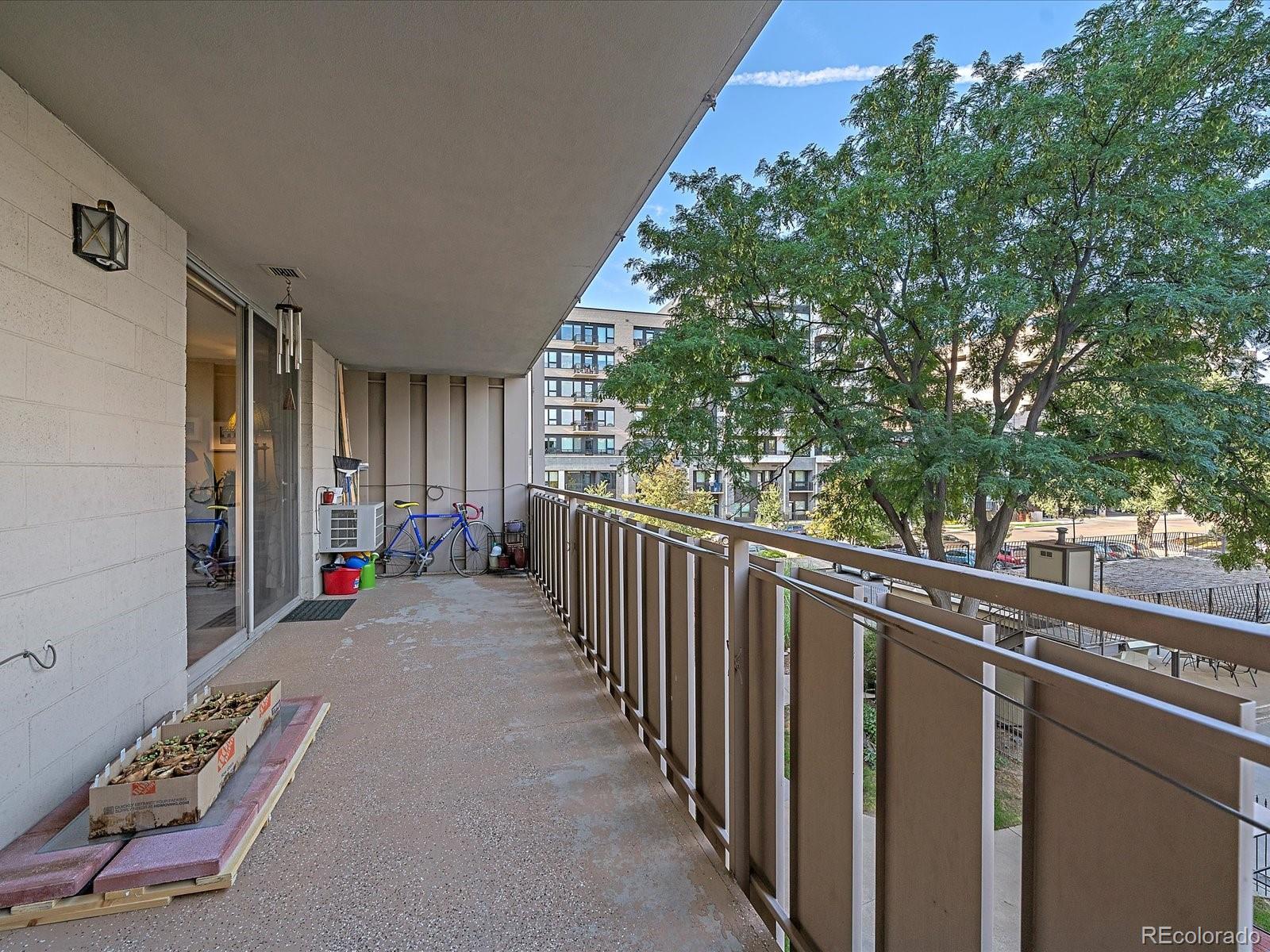 1111 Ash Street, Unit 307 Denver, CO 80220 - Photo 19 of 21 a view of a porch with wooden floor and fence