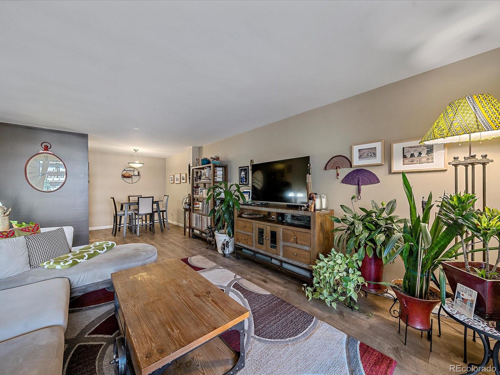 1111 Ash Street, Unit 307 Denver, CO 80220 - Photo 7 of 21 a living room with furniture and a flat screen tv