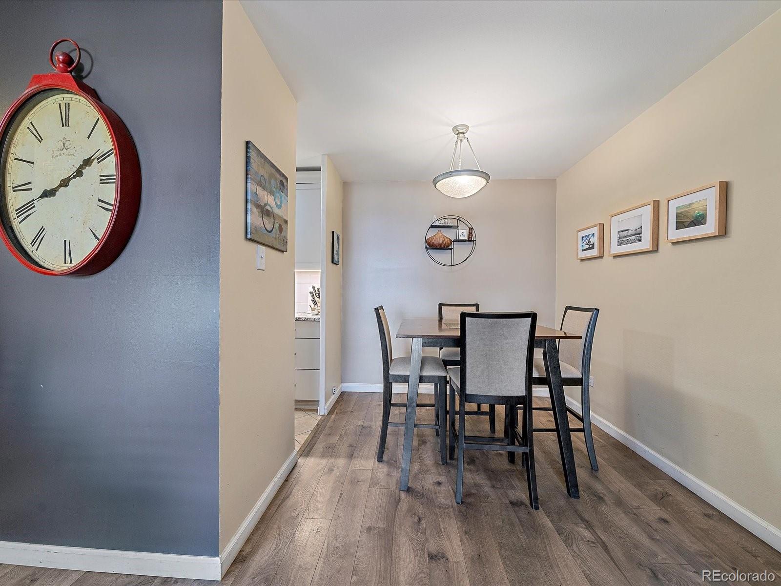 1111 Ash Street, Unit 307 Denver, CO 80220 - Photo 8 of 21 a view of a dining room with furniture and wooden floor
