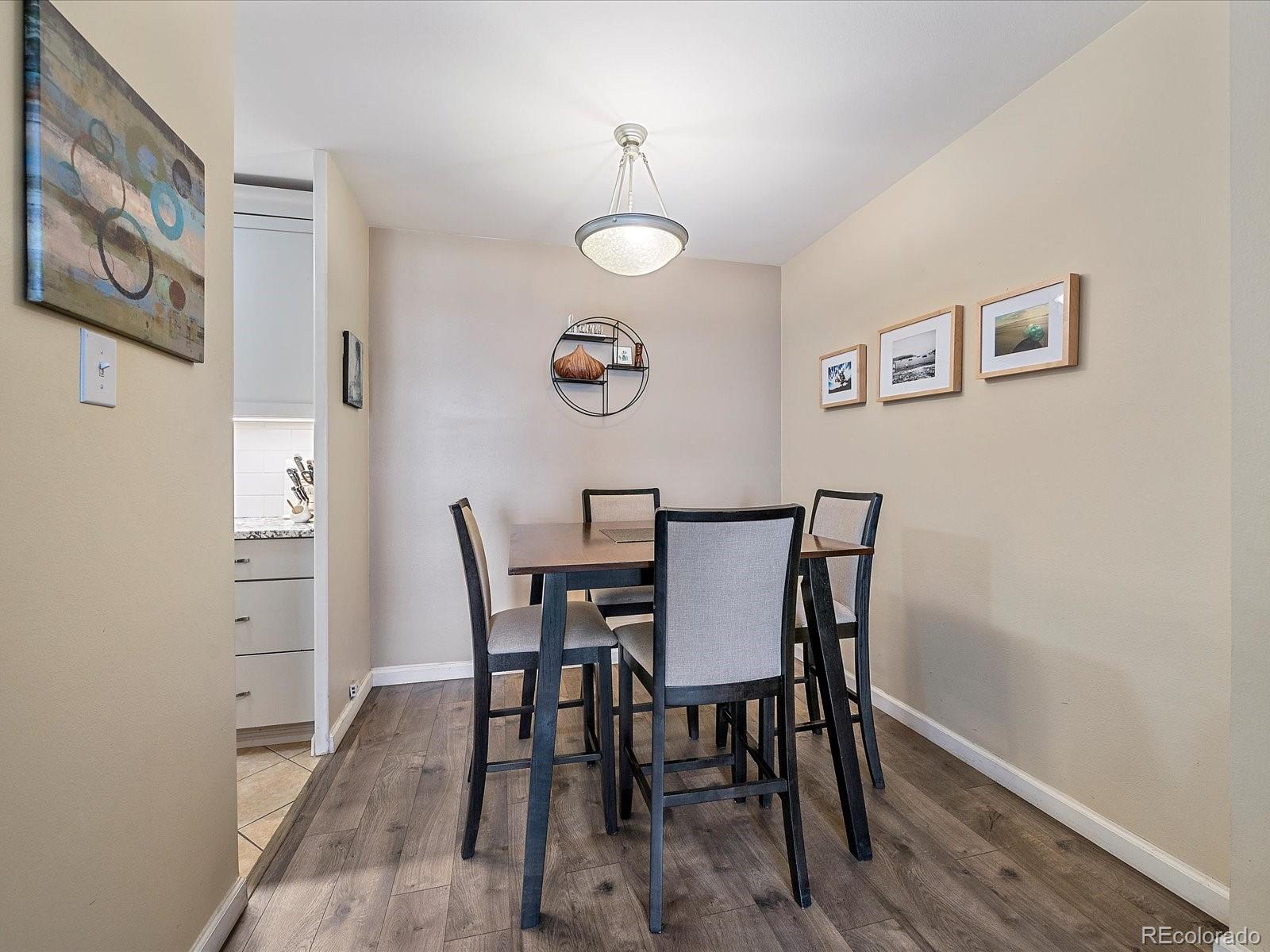 1111 Ash Street, Unit 307 Denver, CO 80220 - Photo 9 of 21 a view of a dining room with furniture and wooden floor