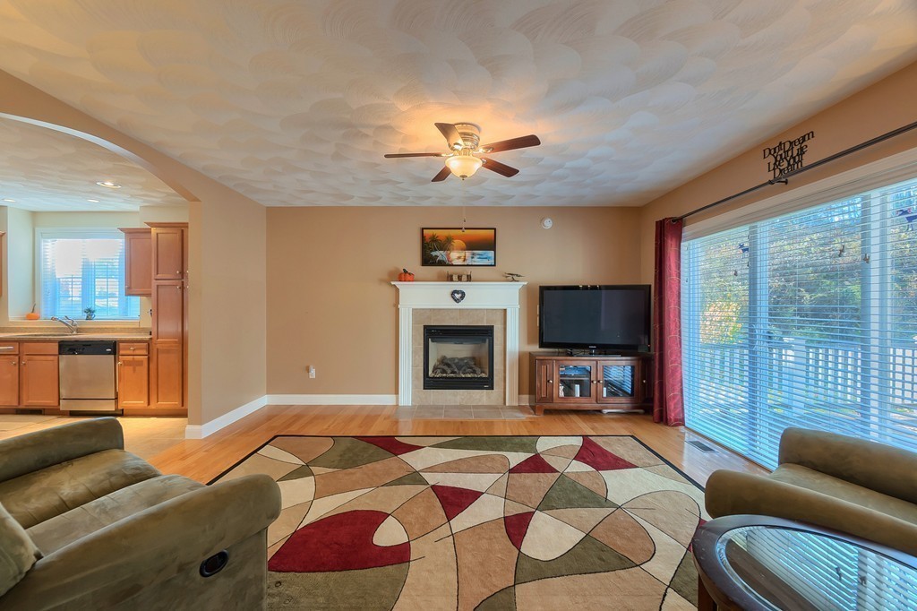 8 A Turtle Hill Road, Unit 8A Ayer, MA 01432 - Photo 11 of 35 a living room with furniture a flat screen tv and a fireplace
