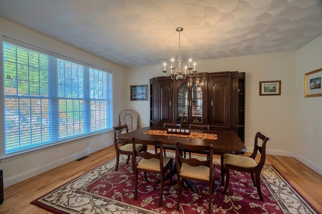 8 A Turtle Hill Road, Unit 8A Ayer, MA 01432 - Photo 13 of 35 a view of a dining room with furniture and chandelier