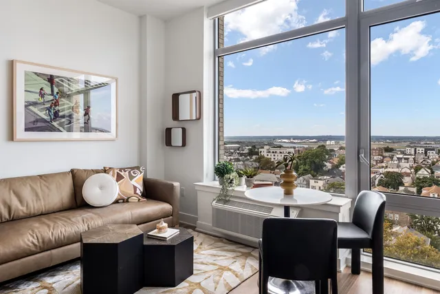 a living room with furniture and a large window with outer view