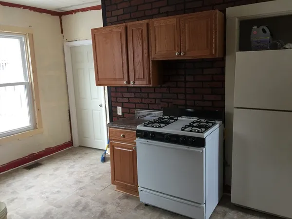 a kitchen with granite countertop a stove and a refrigerator