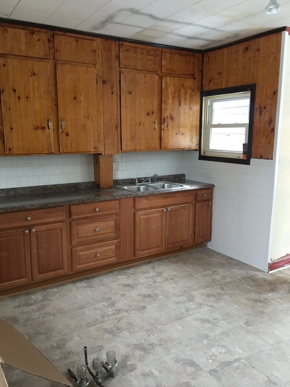 123 Danforth Street, Unit 1S Fall River, MA 02720 - Photo 2 of 8 a view of a kitchen with wooden cabinets