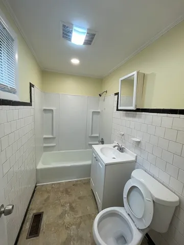a bathroom with a sink a toilet and bathtub