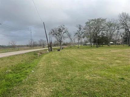 a view of a field with an trees in the background