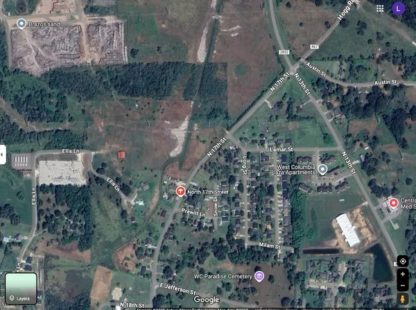 a big yard with trees in the background