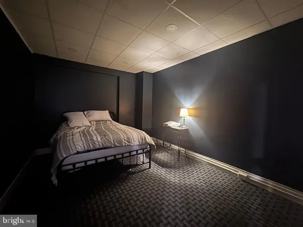 a bed sitting in a room next to a lamp
