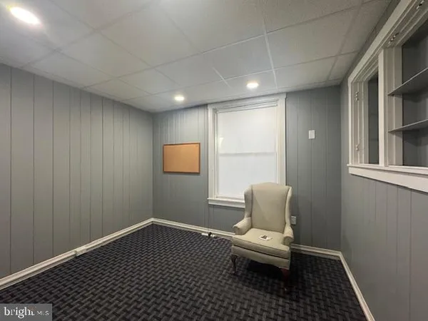 a bathroom with a toilet and a window