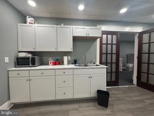a kitchen with a sink cabinets and window