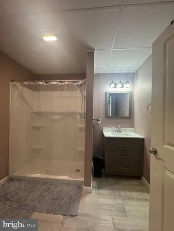 a bathroom with a shower and a sink