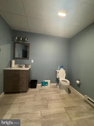 a bathroom with a sink vanity and toilet