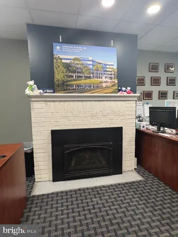 a living room with a fireplace and a flat screen tv