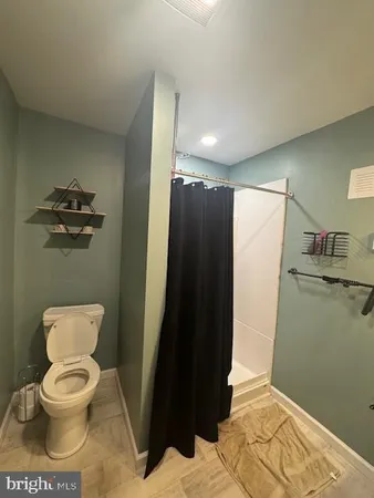 a kitchen with refrigerator and cabinets