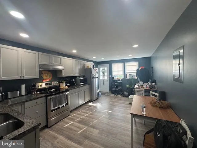 a living room with furniture a rug and a chandelier