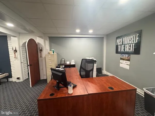a room with furniture a air conditioner vent and a window