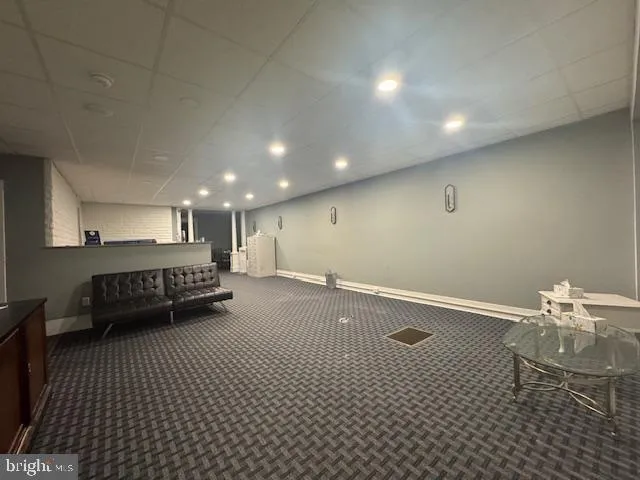 a room with a baby crib furniture and a wooden floor