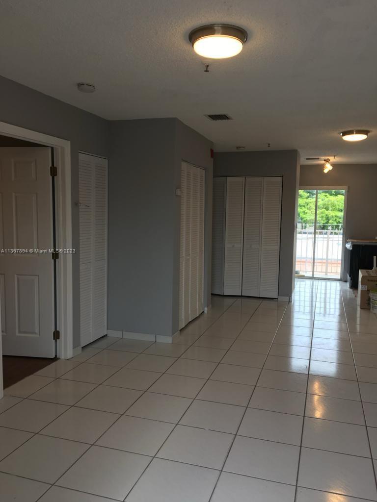 1852 Southwest 7th Street, Unit 309 Miami, FL 33135 - Photo 2 of 12 an empty room with windows and cabinet
