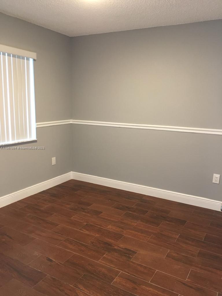 1852 Southwest 7th Street, Unit 309 Miami, FL 33135 - Photo 6 of 12 a view of a room with wooden floor and window