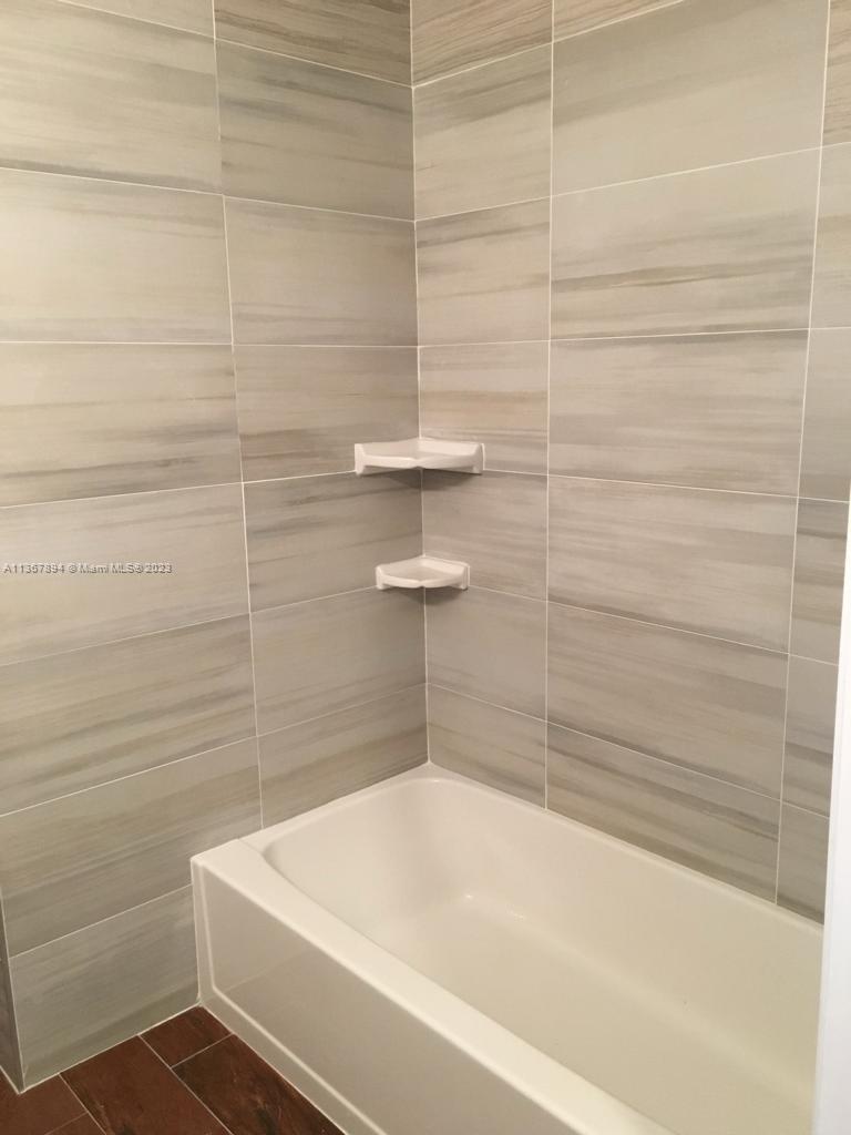 1852 Southwest 7th Street, Unit 309 Miami, FL 33135 - Photo 8 of 12 a bathroom with a white bath tub