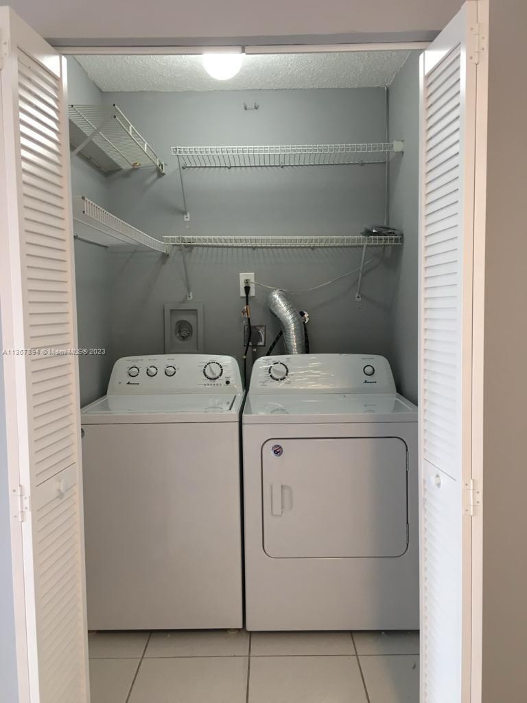 1852 Southwest 7th Street, Unit 309 Miami, FL 33135 - Photo 9 of 12 a utility room with dryer and washer
