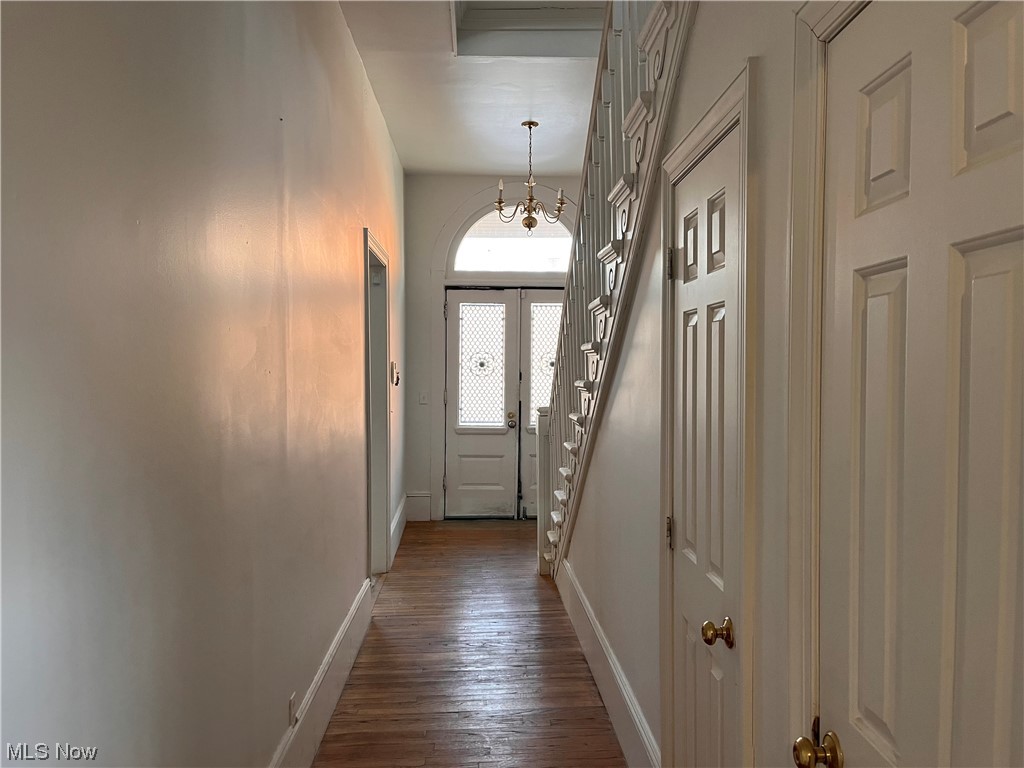 1697 Fulton Road Cleveland, OH 44113 - Photo 9 of 23 Doorway with an inviting chandelier, dark wood-type flooring, a high ceiling, and french doors