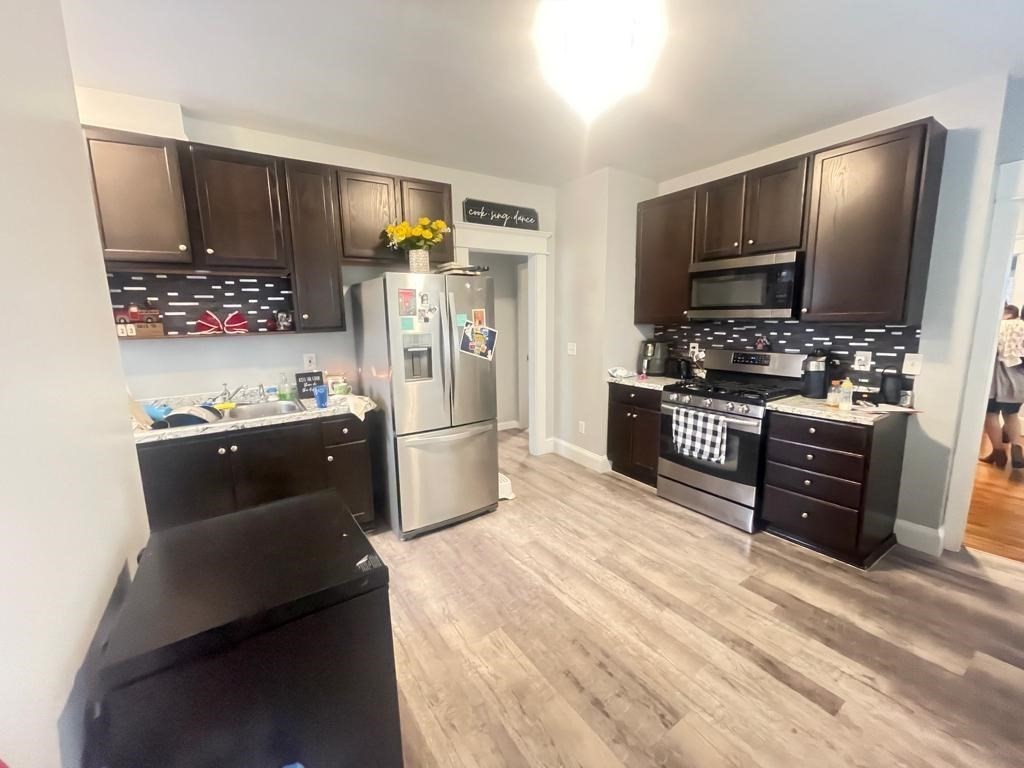 32-34 Rittenhouse Terrace Springfield, MA 01108 - Photo 3 of 23 a kitchen with stainless steel appliances kitchen island granite countertop a refrigerator stove and oven