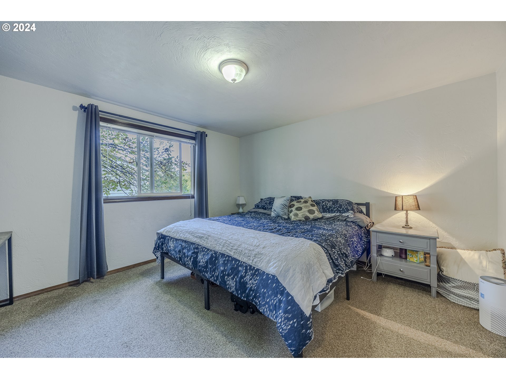 6780 D Court Springfield, OR 97478 - Photo 41 of 45 a spacious bedroom with a bed a window and walk in closet