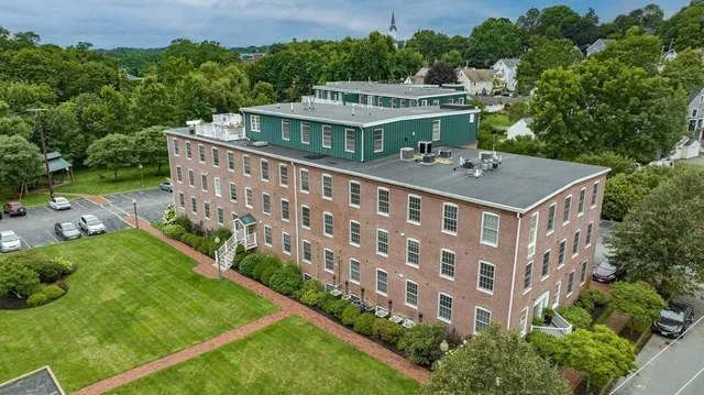 an aerial view of a house with a yard