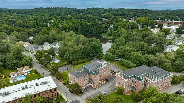 an aerial view of a house with a yard