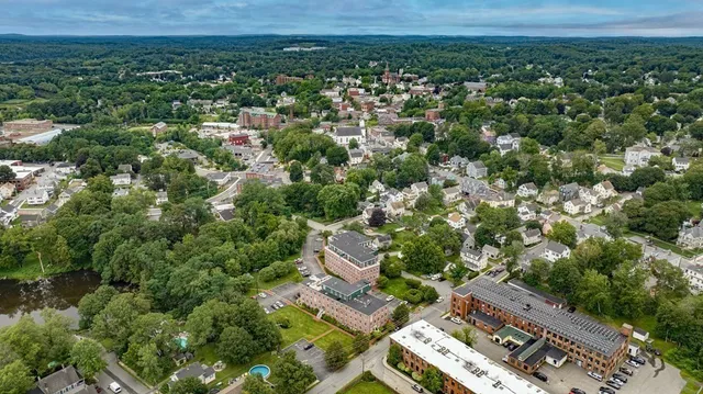 an aerial view of a house with a yard