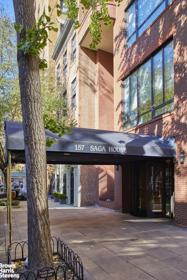 157 East 74th Street, Unit 10B Manhattan, NY 10021 - Photo 13 of 14 a front view of a house with a yard and garage