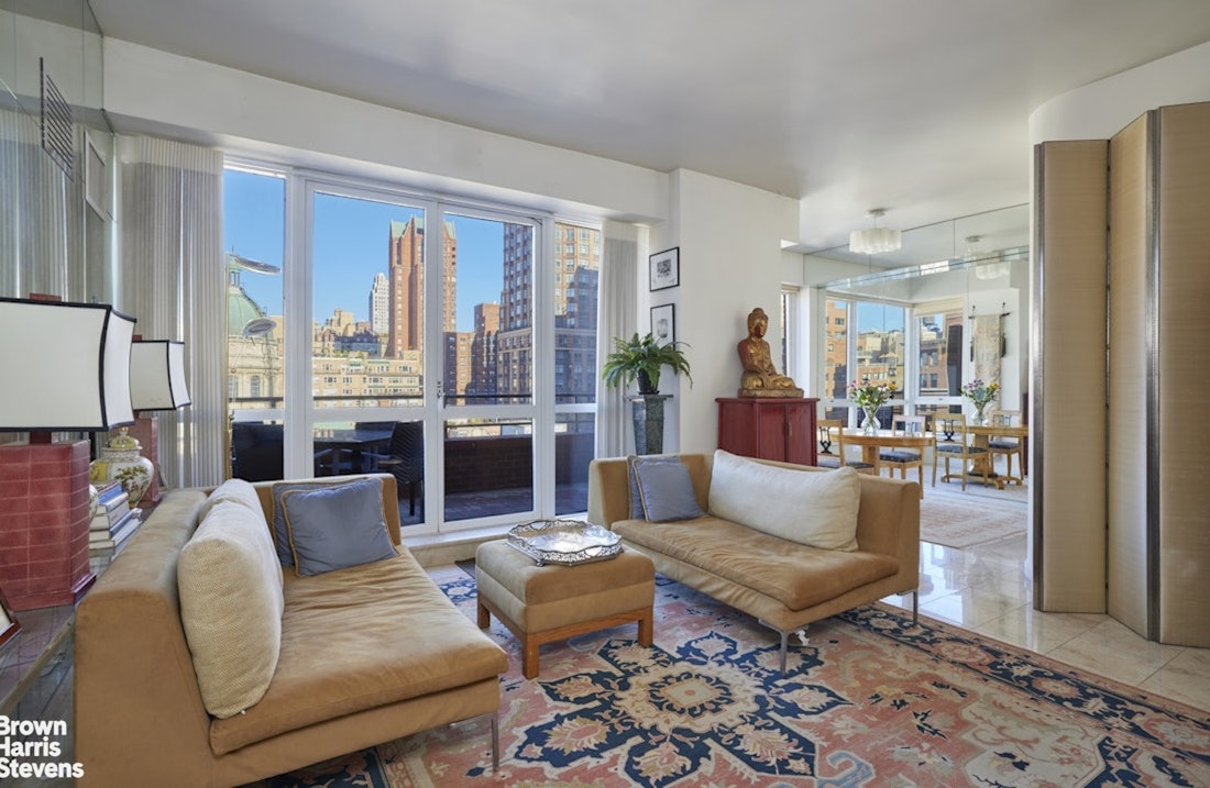 157 East 74th Street, Unit 10B Manhattan, NY 10021 - Photo 2 of 14 a living room with furniture and a large window