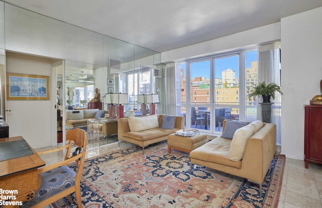 157 East 74th Street, Unit 10B Manhattan, NY 10021 - Photo 5 of 14 a living room with furniture fireplace and a large window