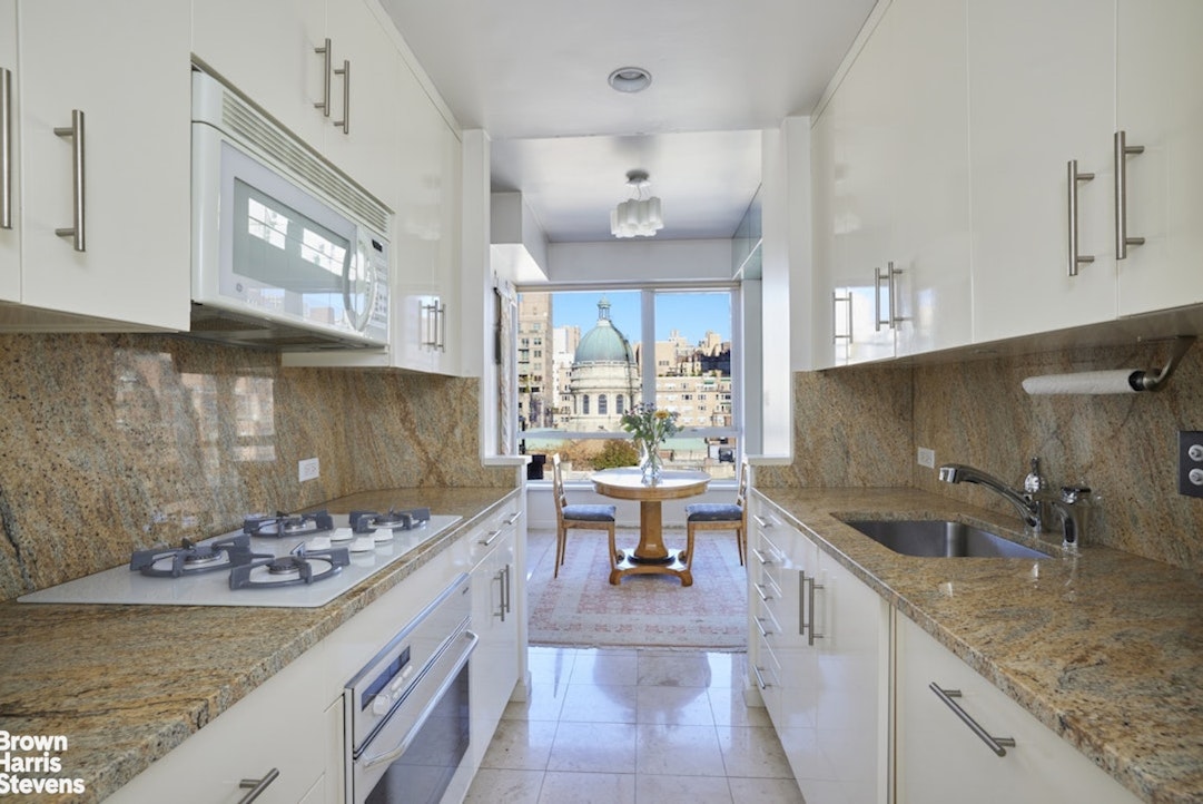 157 East 74th Street, Unit 10B Manhattan, NY 10021 - Photo 6 of 14 a kitchen with a sink stove and cabinets