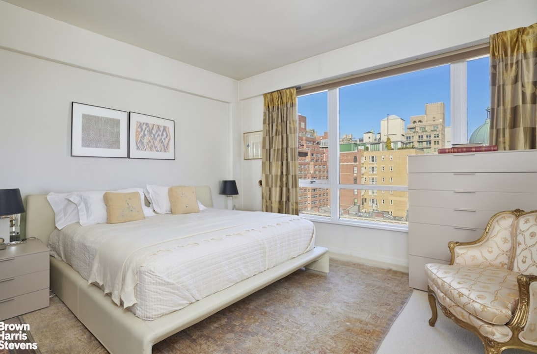 157 East 74th Street, Unit 10B Manhattan, NY 10021 - Photo 7 of 14 a bedroom with a bed and glass window