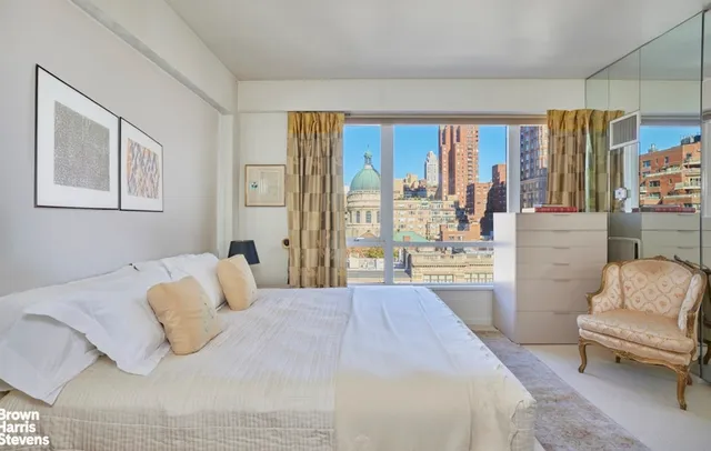 a bedroom with a bed and glass window
