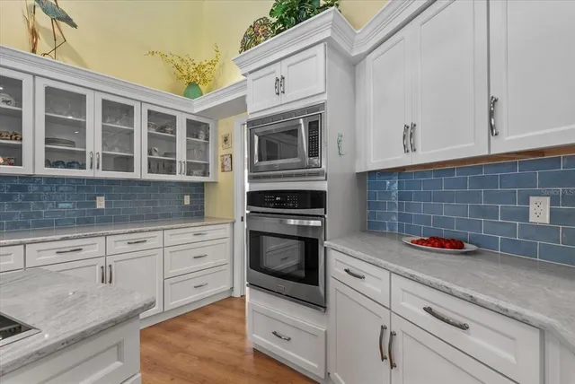 a spacious bedroom with a bed and a chandelier