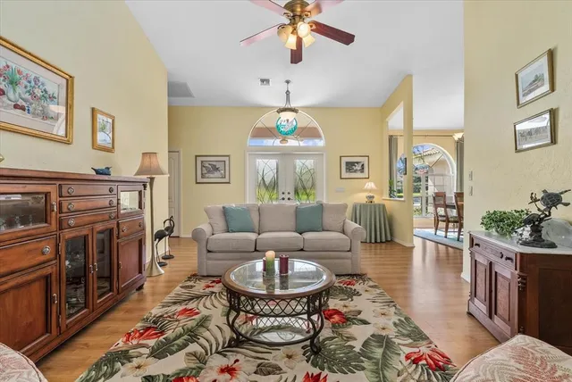 a view of a dining room with furniture wooden floor and chandelier