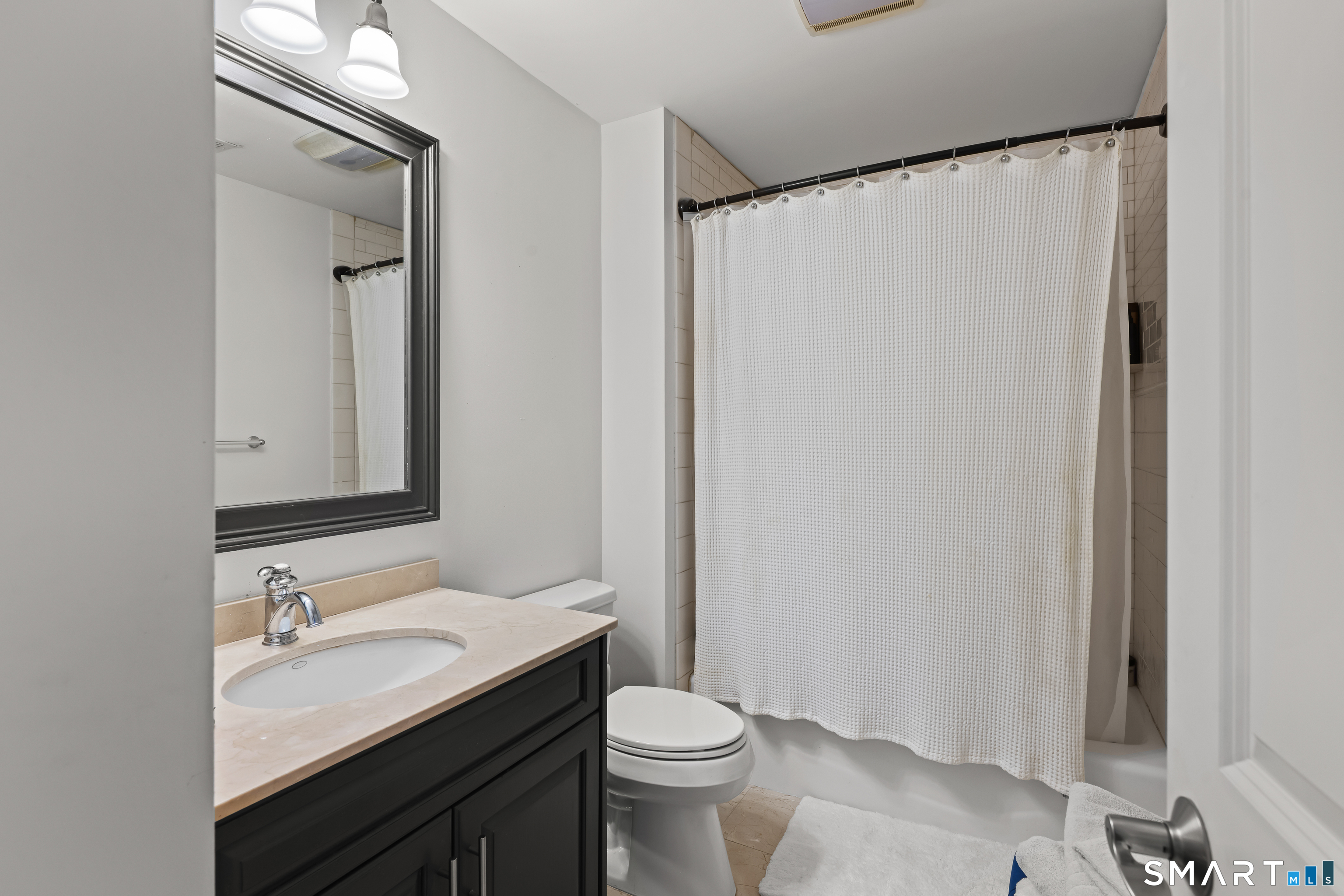 71 Aberdeen Way, Unit 71 Fairfield, CT 06890 - Photo 25 of 37 a bathroom with a granite countertop sink toilet and shower