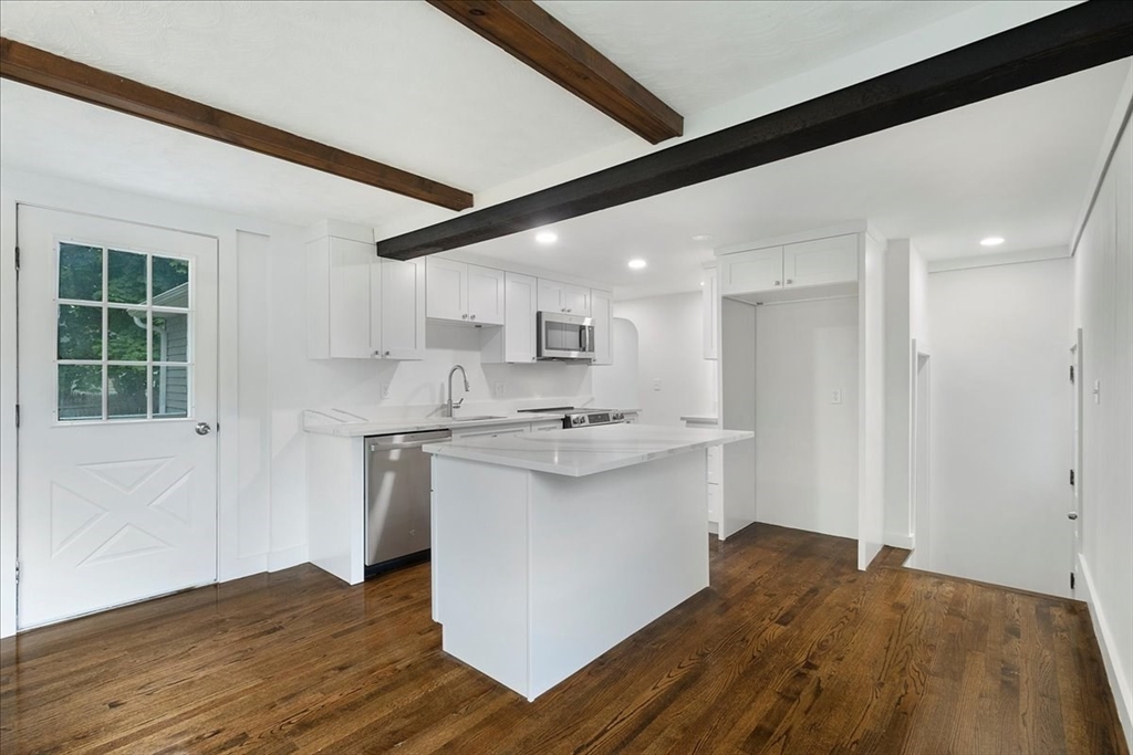 5 Rondeau Road Bellingham, MA 02019 - Photo 14 of 32 a kitchen with stainless steel appliances granite countertop a white cabinets and wooden floor