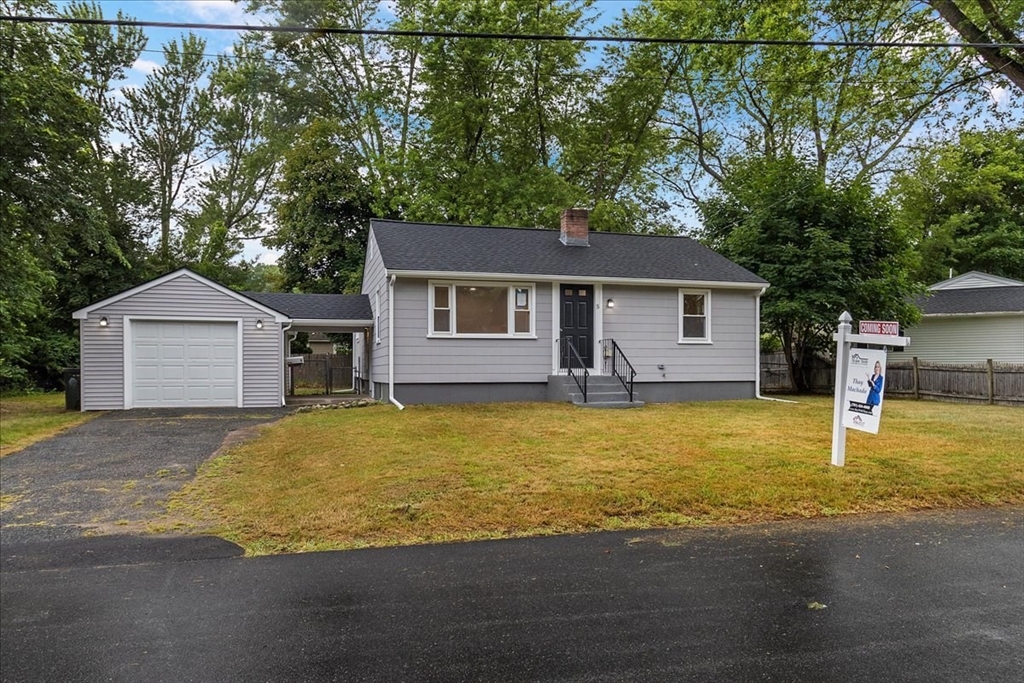 5 Rondeau Road Bellingham, MA 02019 - Photo 2 of 32 a front view of a house with a yard and garage