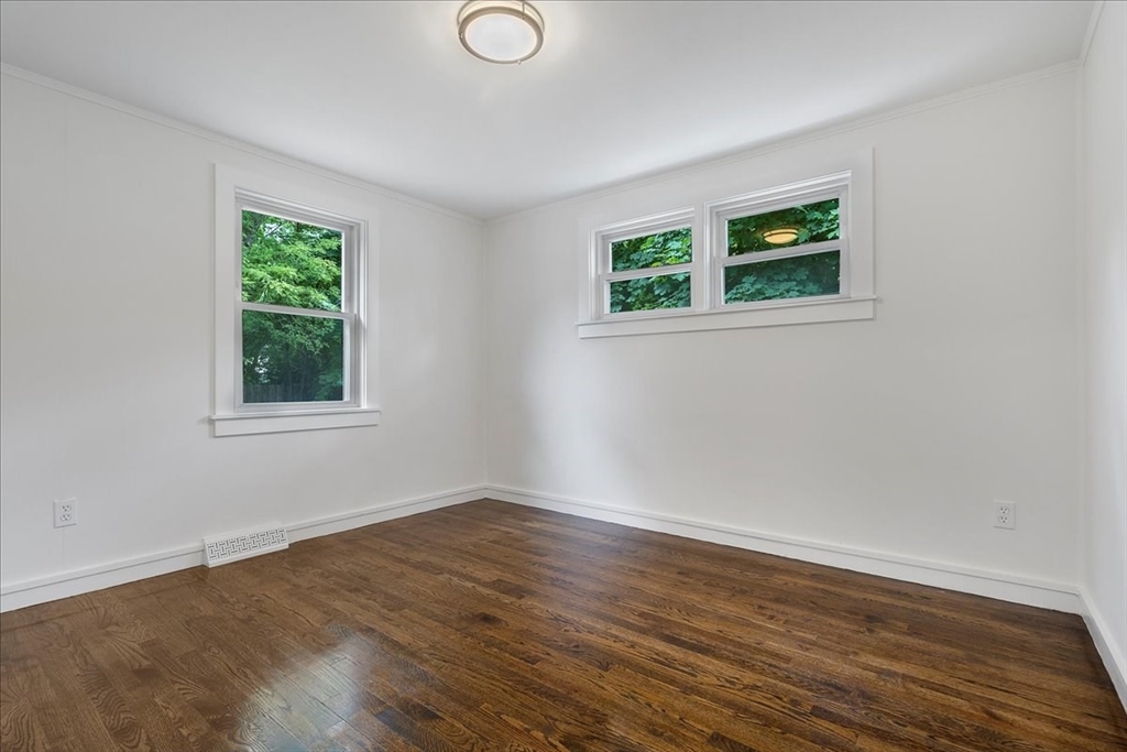 5 Rondeau Road Bellingham, MA 02019 - Photo 21 of 32 a view of an empty room with wooden floor and a window