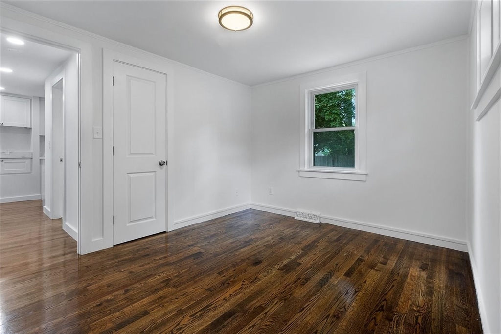 5 Rondeau Road Bellingham, MA 02019 - Photo 22 of 32 a view of an empty room with wooden floor and a window
