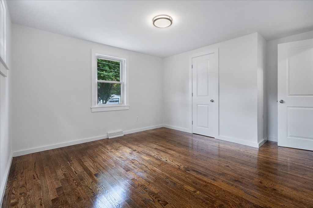 5 Rondeau Road Bellingham, MA 02019 - Photo 23 of 32 an empty room with wooden floor and windows