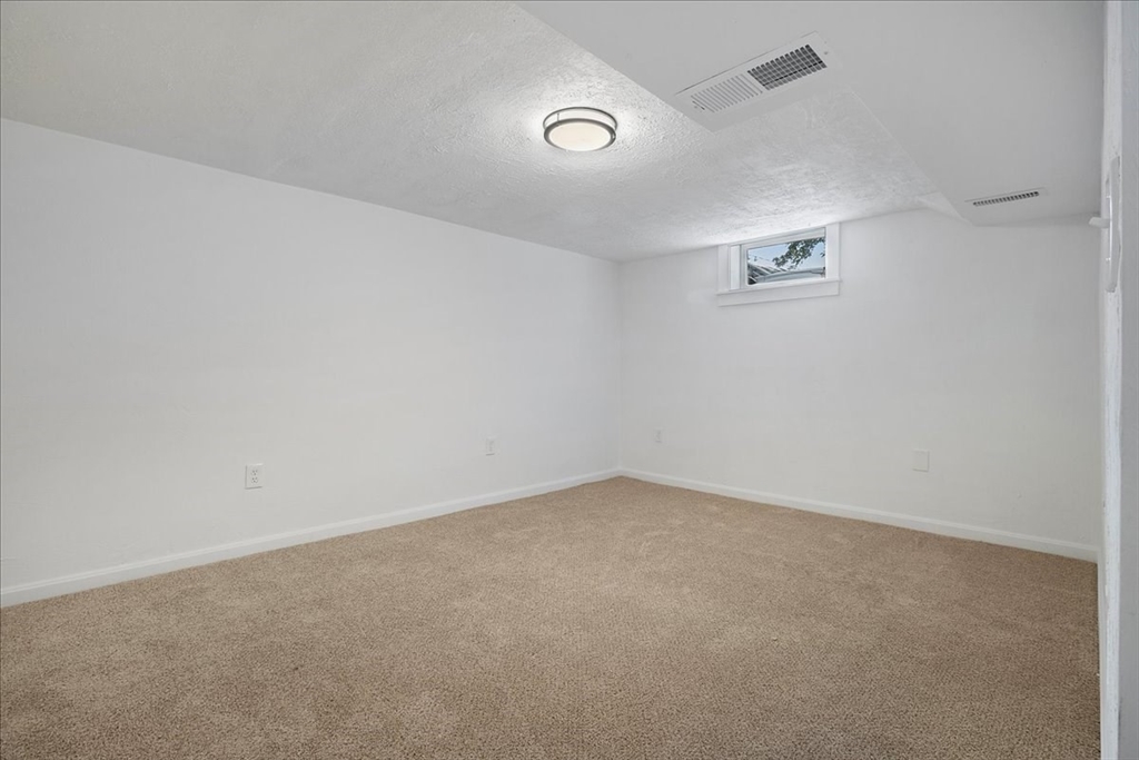 5 Rondeau Road Bellingham, MA 02019 - Photo 25 of 32 an empty room with a workbench