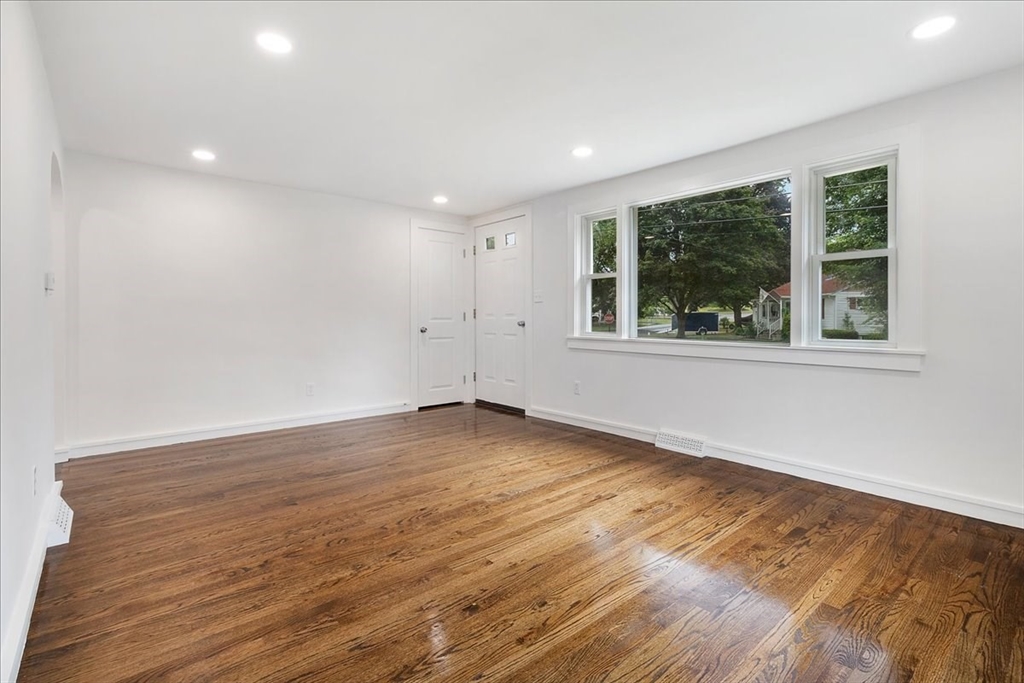 5 Rondeau Road Bellingham, MA 02019 - Photo 10 of 32 an empty room with wooden floor and windows