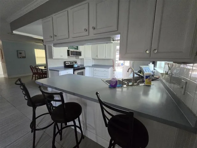 a kitchen with a sink cabinets and outdoor seating